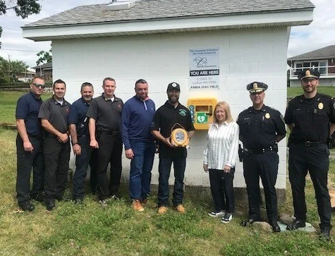 (From left to right) Firefighter Nate Keaton, Fire Captain Seth Falconer, Fire Captain Bill Dubuque, Fire Chief Ryan Pease, Western United Pioneers Board Member Joe Salvador, Rob Smith, Lumberjack Hockey Team representative (the team raised funds for the KEVS Foundation during the Kevin G. Major Memorial Hockey Tournament, Maria Gomes, Anna Dias Foundation, Chief of Police Daniel Valadas, Police Lieutenant David Irwin. (Photo courtesy Town of Ludlow)